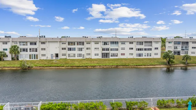 a view of a lake with houses in the back