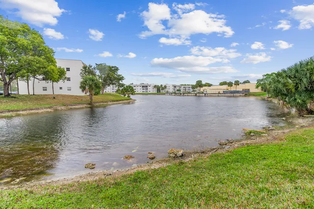 a view of a lake with houses in the back