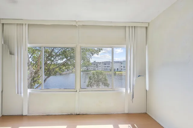 a room with a large window and a bed