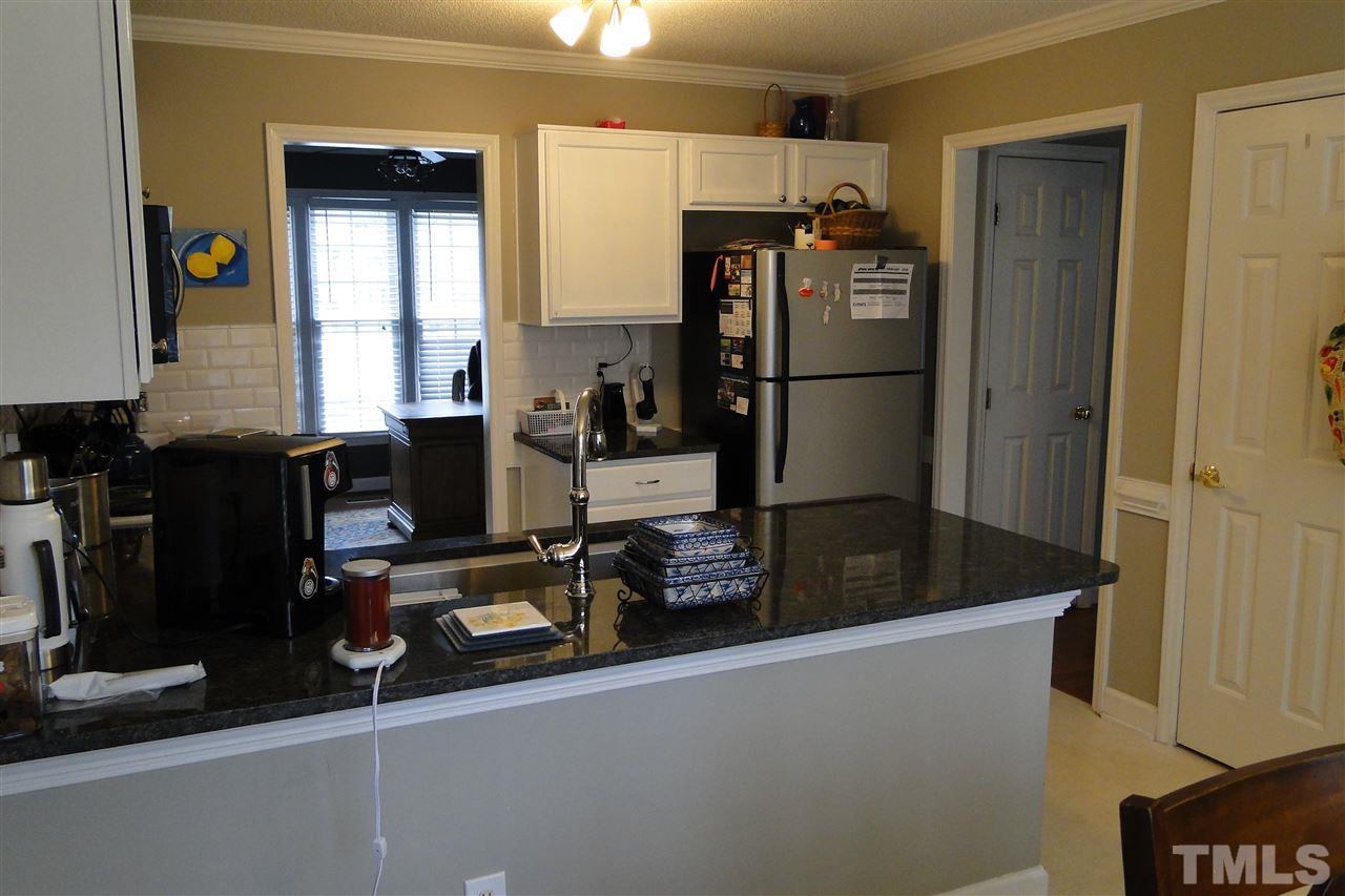 4105 Landrum Lane Raleigh, NC 27616 - Photo 12 of 29 a kitchen with a refrigerator and a counter top space