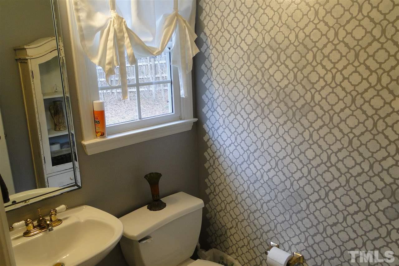 4105 Landrum Lane Raleigh, NC 27616 - Photo 13 of 29 a bathroom with a toilet sink and mirror