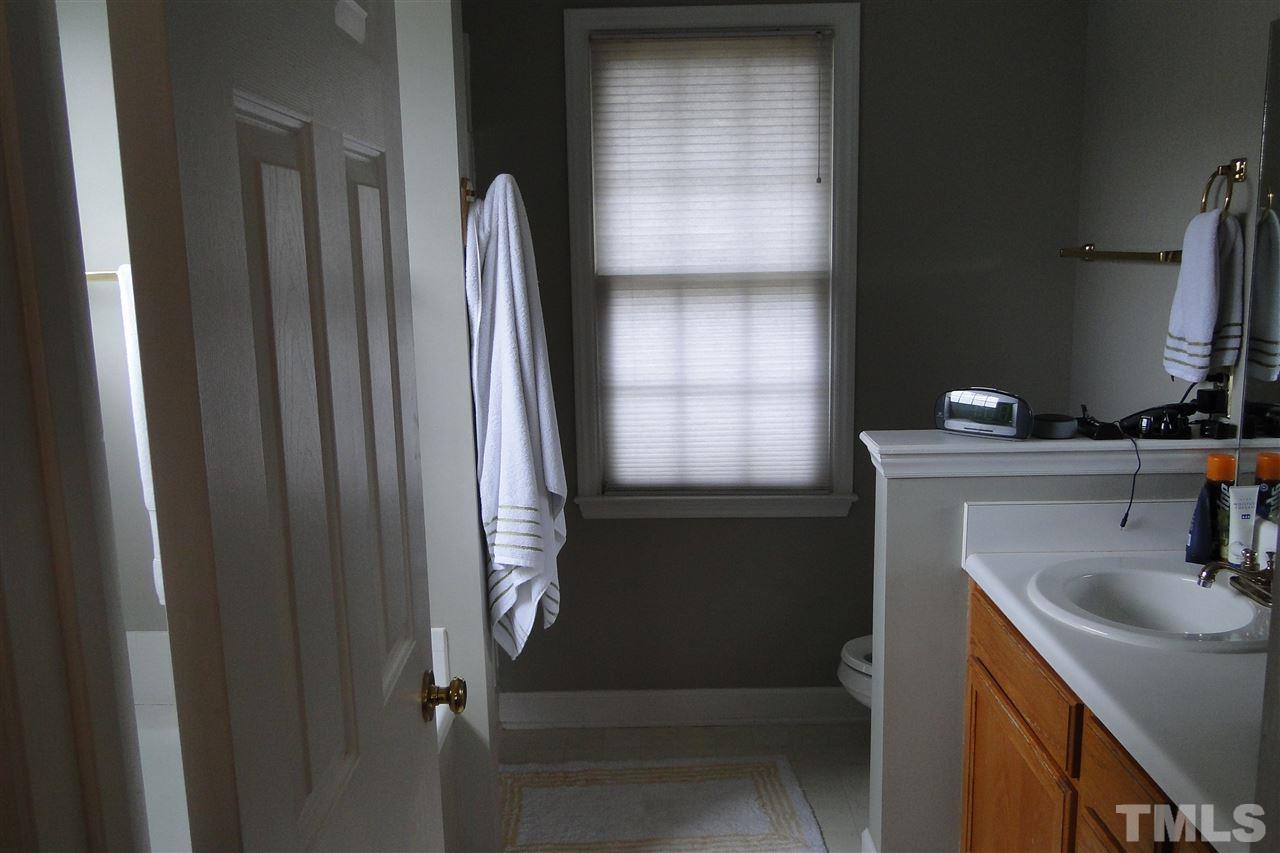 4105 Landrum Lane Raleigh, NC 27616 - Photo 16 of 29 a bathroom with a sink a toilet and vanity