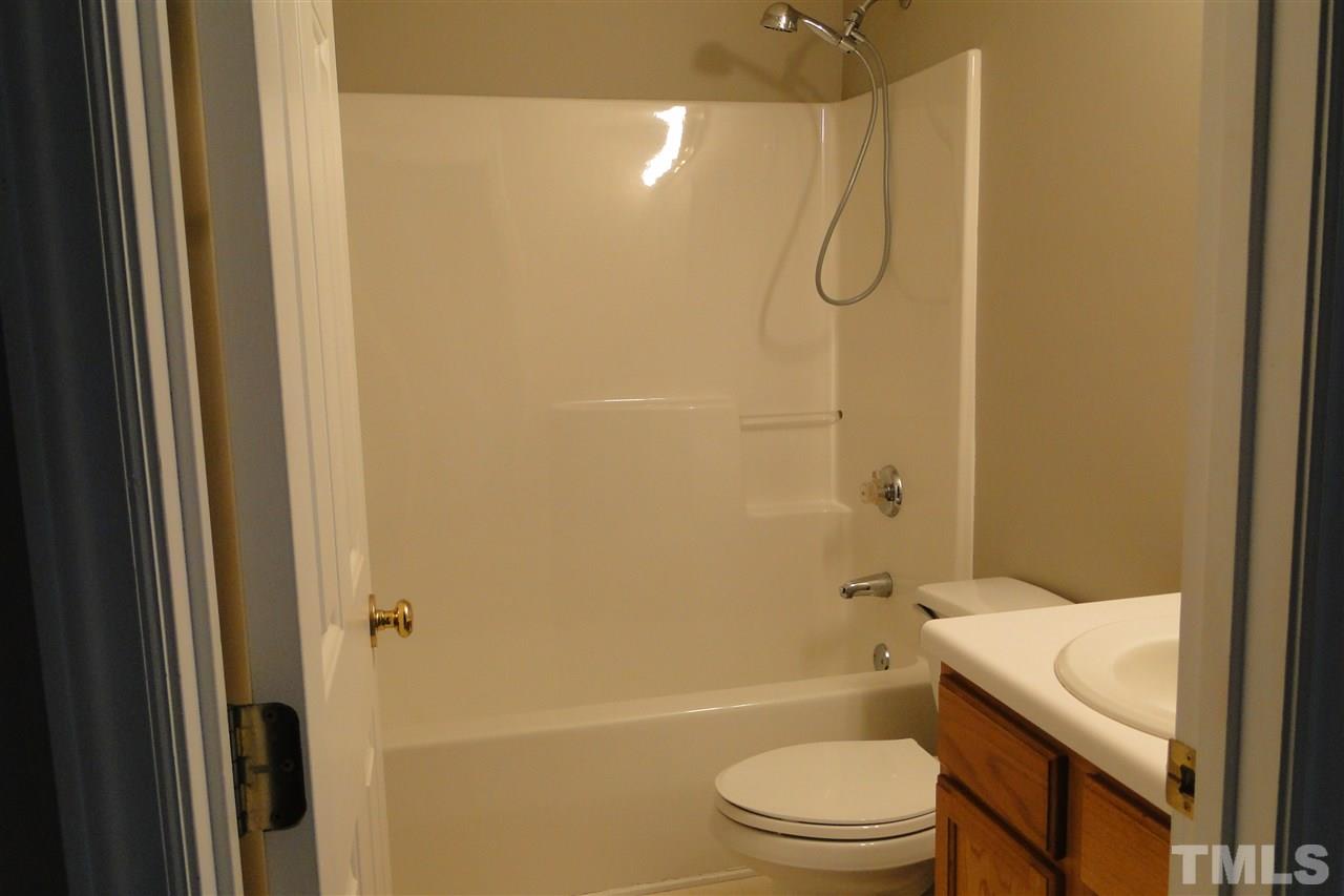 4105 Landrum Lane Raleigh, NC 27616 - Photo 20 of 29 a bathroom with a shower a toilet and sink