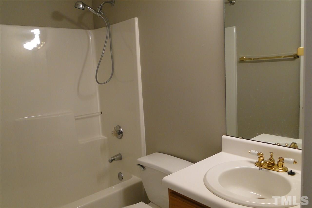 4105 Landrum Lane Raleigh, NC 27616 - Photo 21 of 29 a bathroom with a sink a toilet and shower