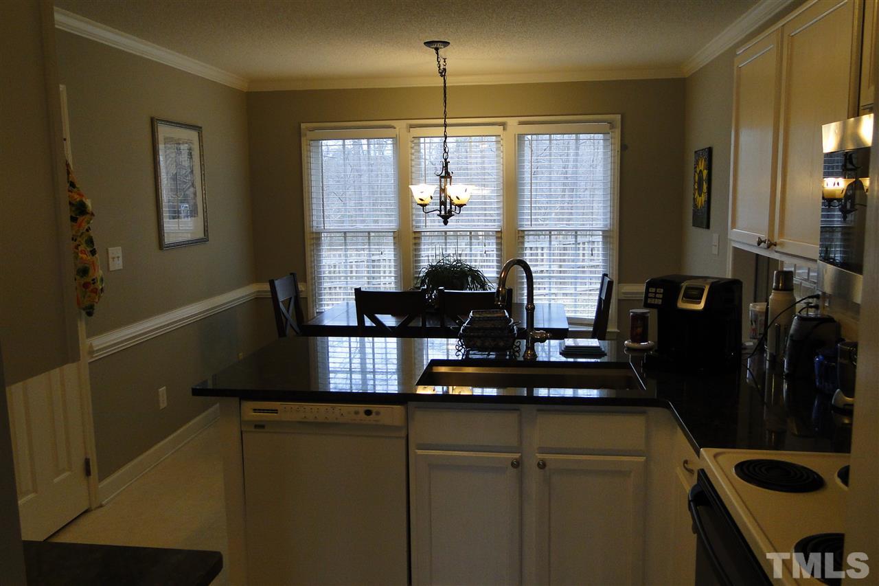 4105 Landrum Lane Raleigh, NC 27616 - Photo 10 of 29 a kitchen with a refrigerator and a window