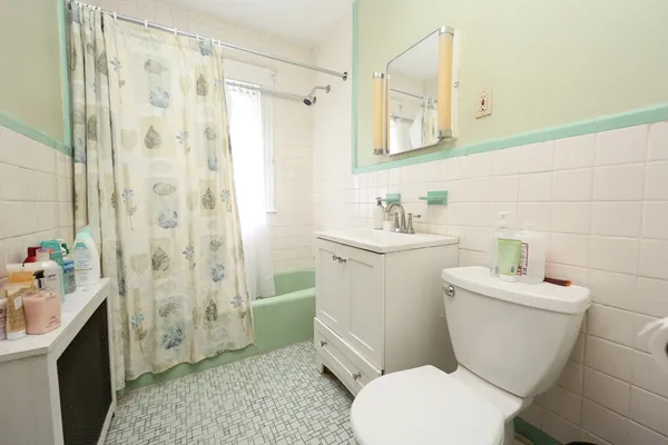 a bathroom with a sink toilet vanity and shower