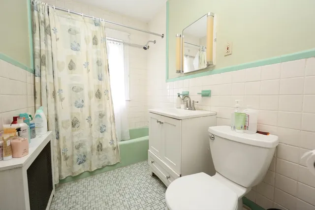 a bathroom with a sink toilet vanity and shower