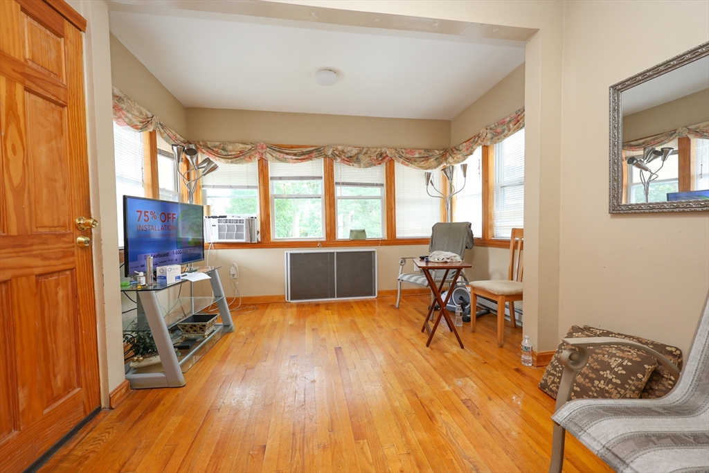 8 Verndale Road, Unit 2 Milton, MA 02186 - Photo 18 of 20 a living room with furniture and a wooden floor