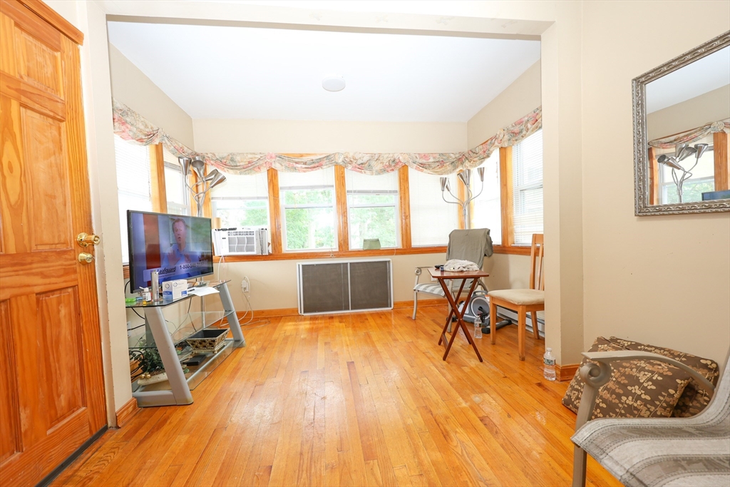 8 Verndale Road, Unit 2 Milton, MA 02186 - Photo 19 of 20 a living room with furniture and a wooden floor