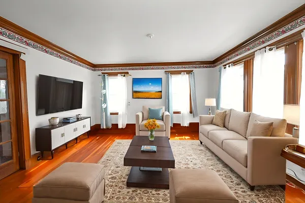 a living room with furniture and a flat screen tv
