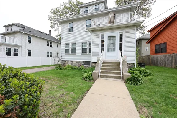 a front view of a house with a garden