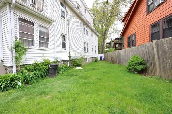 a view of a house with a yard and plants