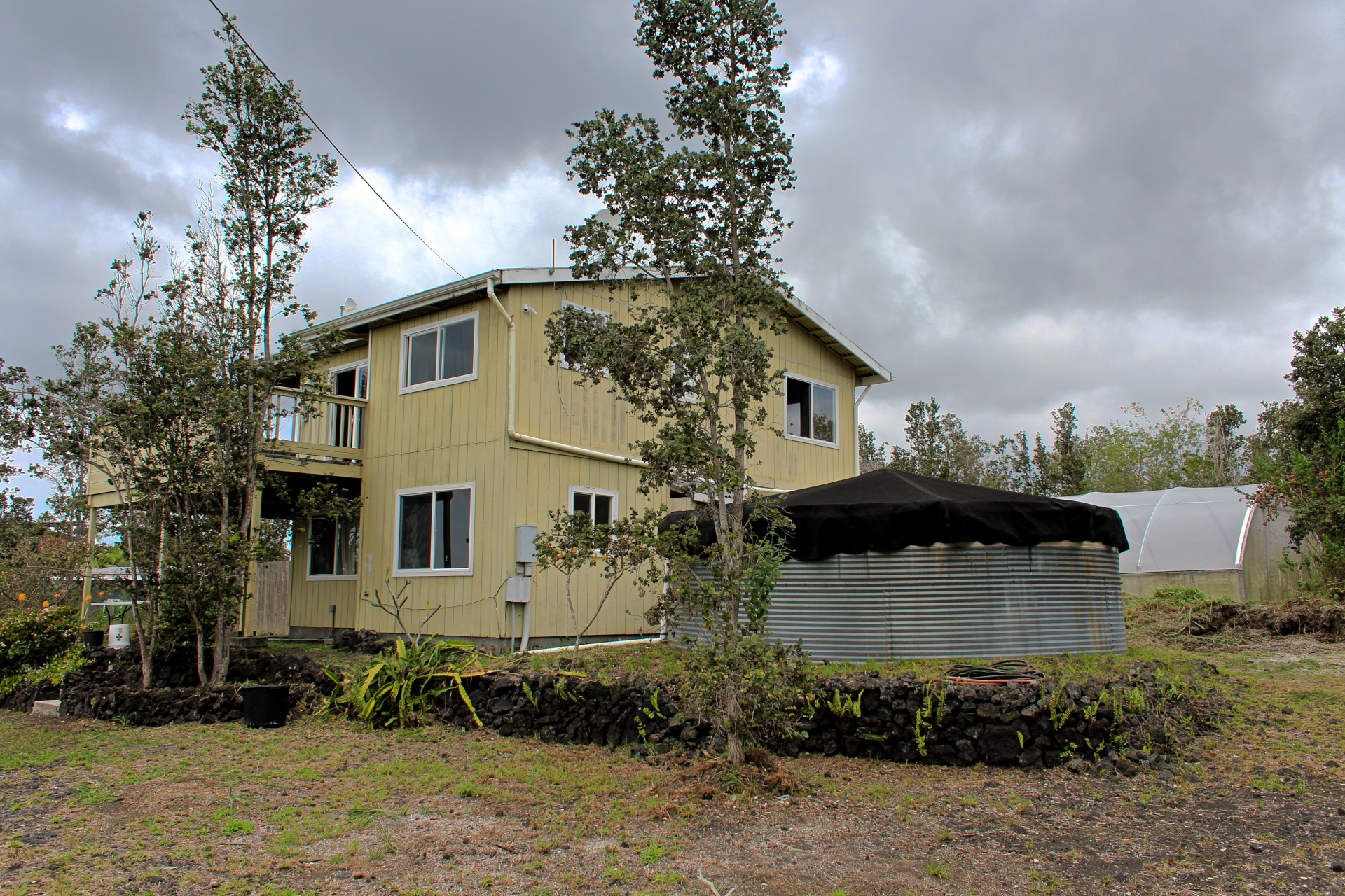 92-1435 Aloha Boulevard Ocean View, HI 96704 - Photo 16 of 28 a view of a house with a yard