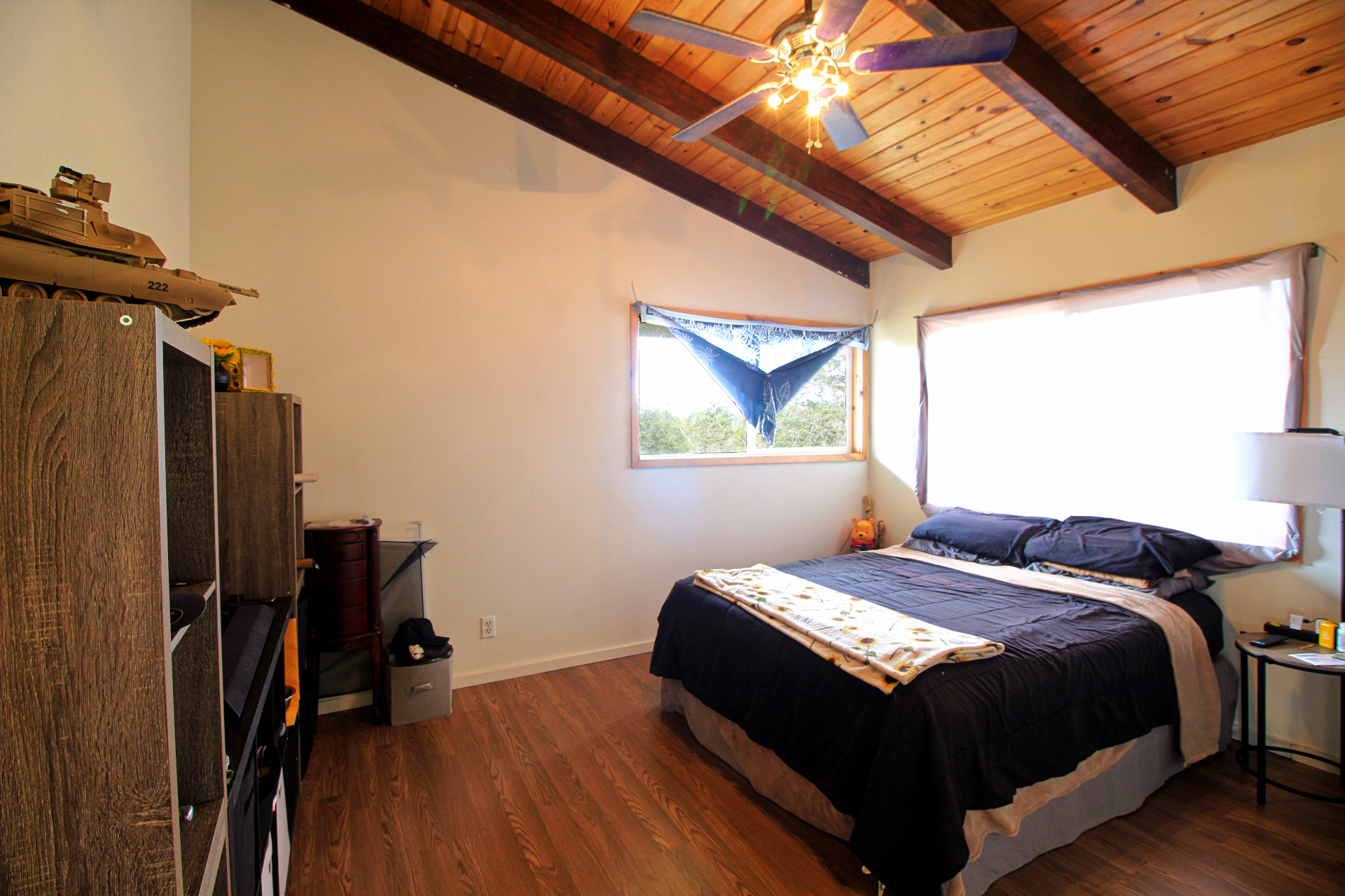 92-1435 Aloha Boulevard Ocean View, HI 96704 - Photo 22 of 28 a bedroom with a bed and wooden floor