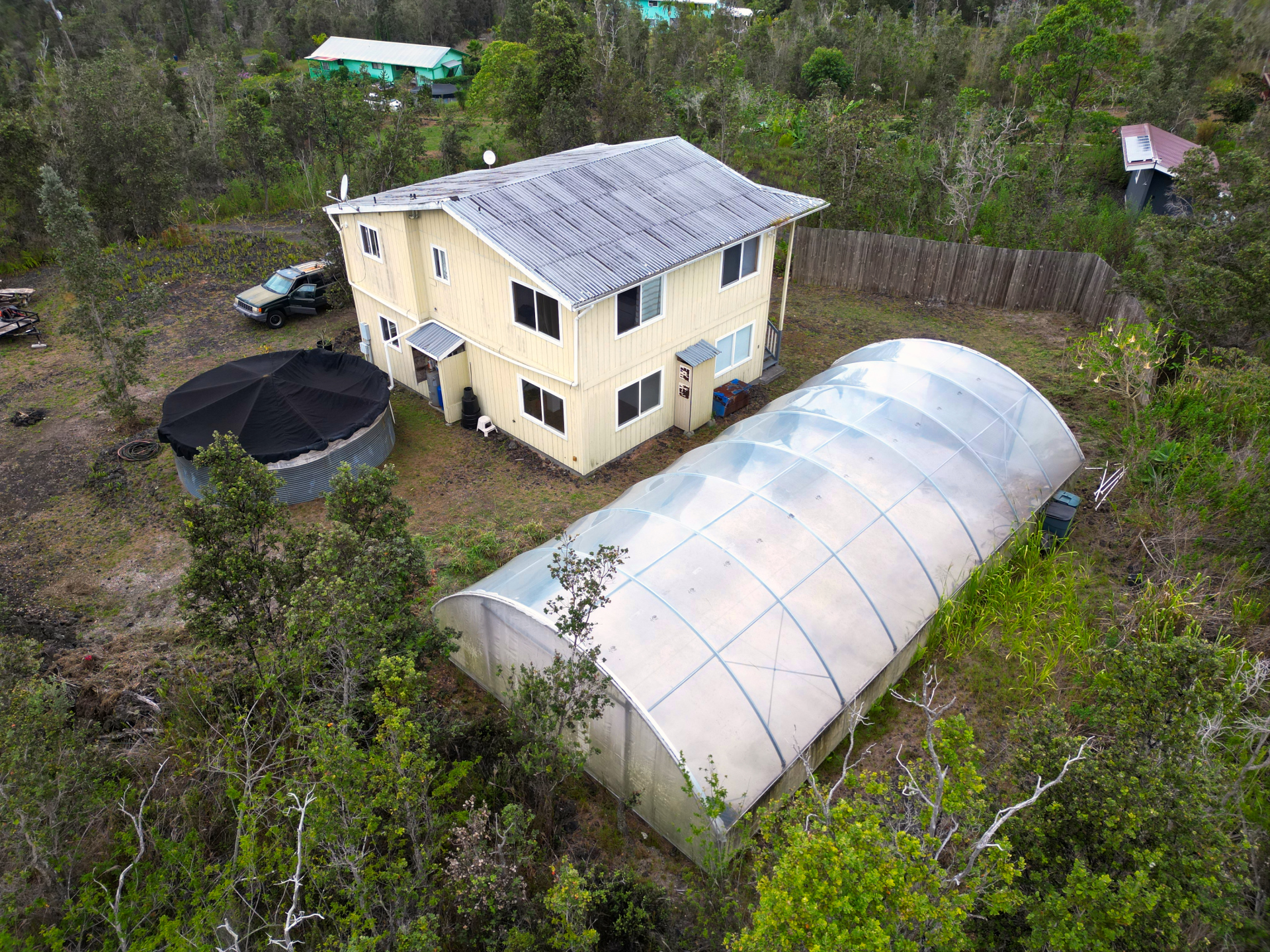 92-1435 Aloha Boulevard Ocean View, HI 96704 - Photo 4 of 28 a aerial view of a house with balcony and trees al around