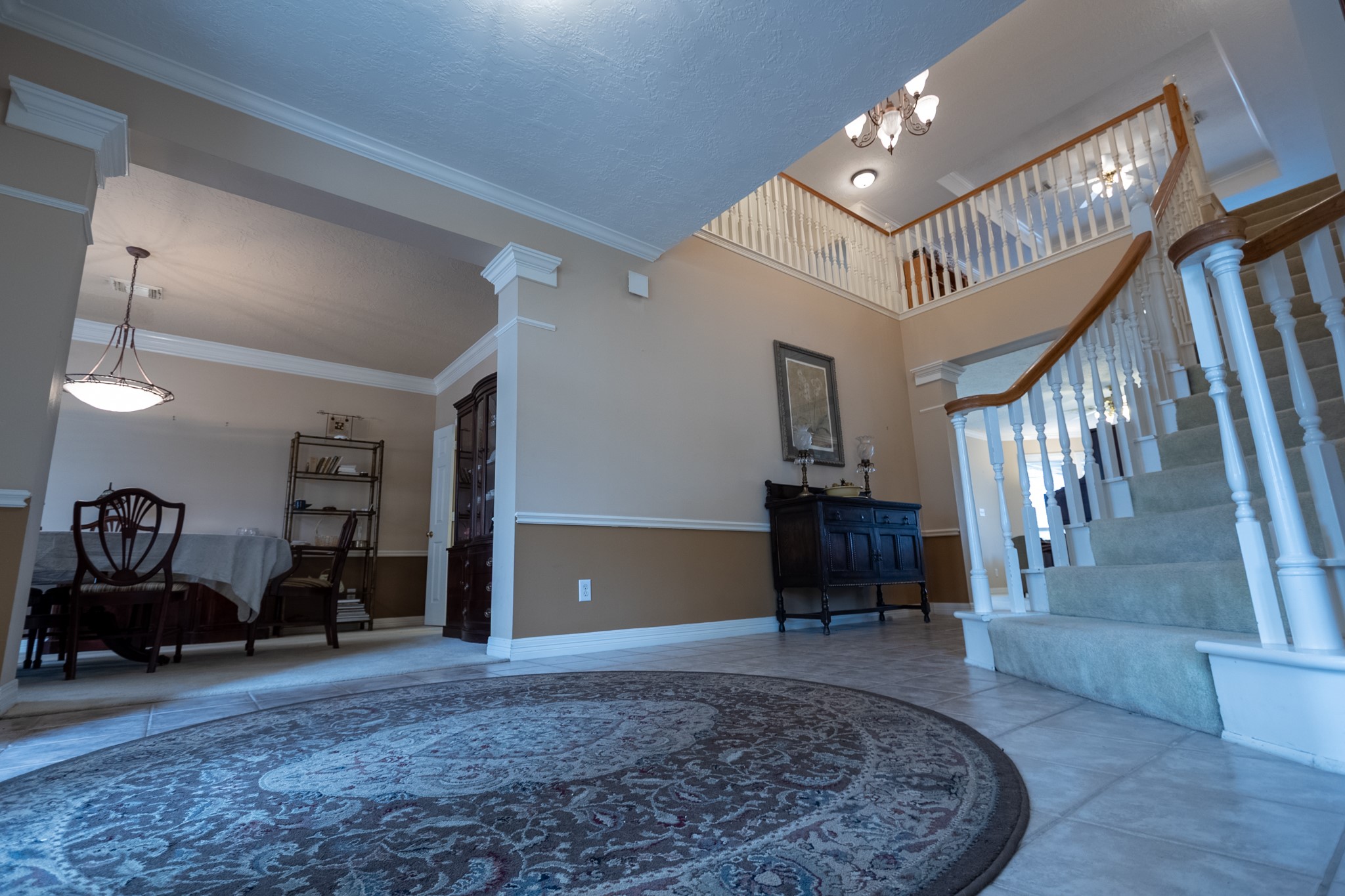 5718 Oakmoss Trail Spring, TX 77379 - Photo 19 of 50 Elegant dining room with crown molding and chair rail—ideal for entertaining.