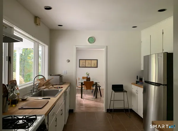 a kitchen with a sink appliances and a counter top space
