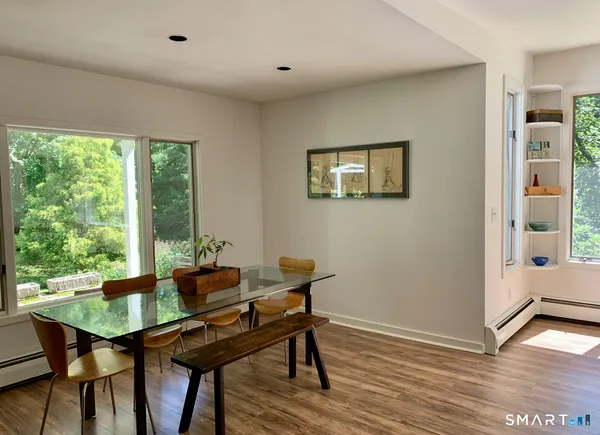 a dining room with furniture and wooden floor