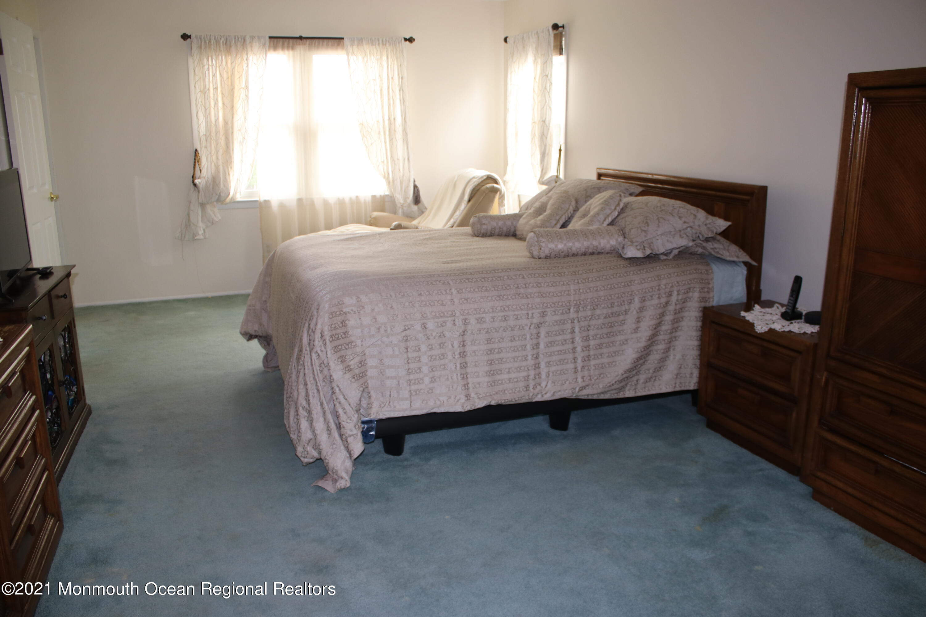 135 Lancaster Road Freehold, NJ 07728 - Photo 23 of 46 a bedroom with a bed and a flat tv screen on dresser