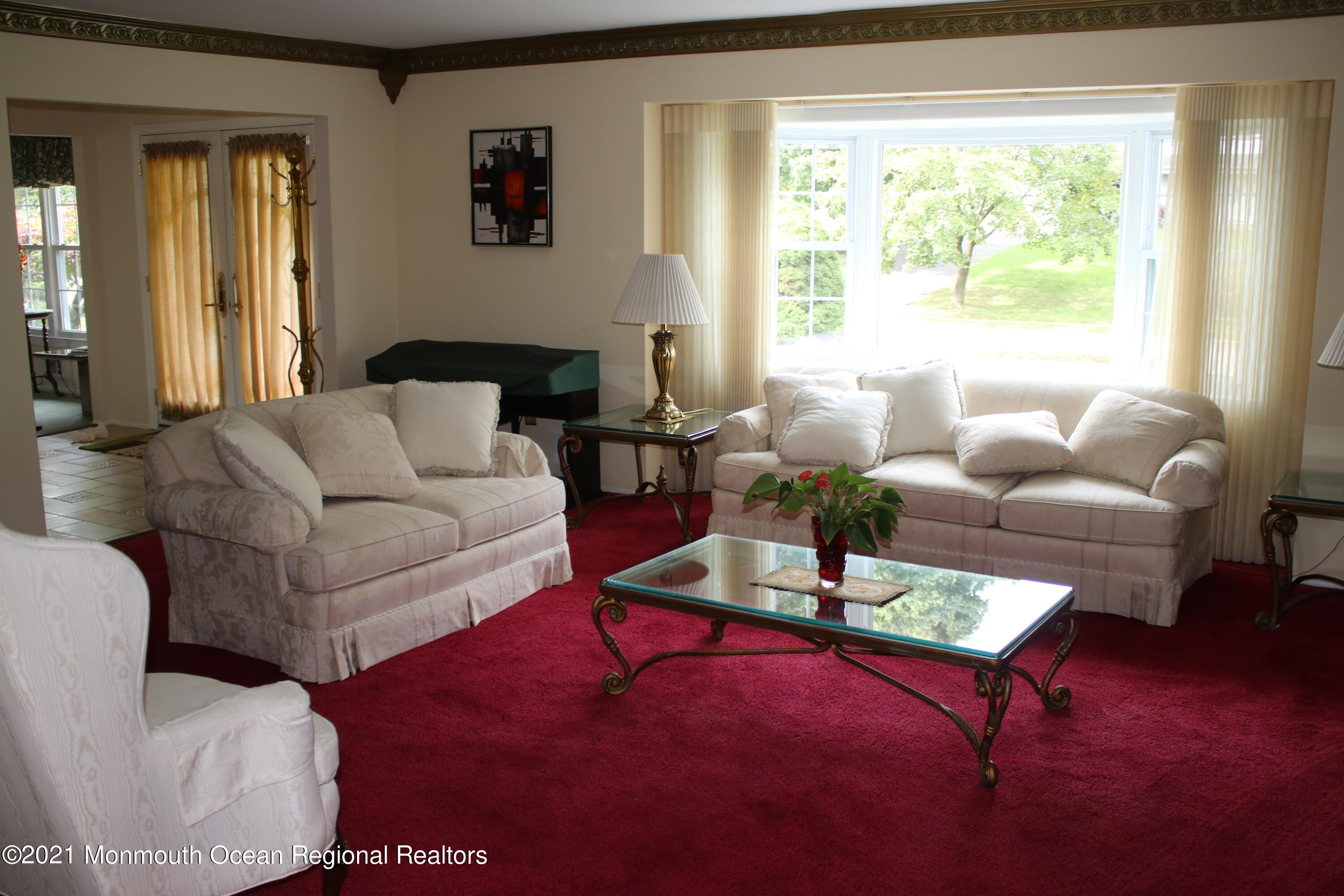 135 Lancaster Road Freehold, NJ 07728 - Photo 8 of 46 a living room with furniture a rug and a large window