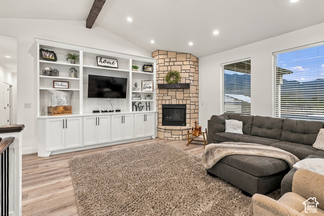 244 East Sevier River Road Central Valley, UT 84754 - Photo 18 of 66 Vaulted ceiling with exposed beam, built-in entertainment center, stone fireplace, wood-finish flooring, and large windows