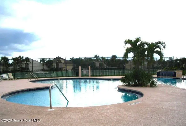 a view of a swimming pool with a yard and lake view