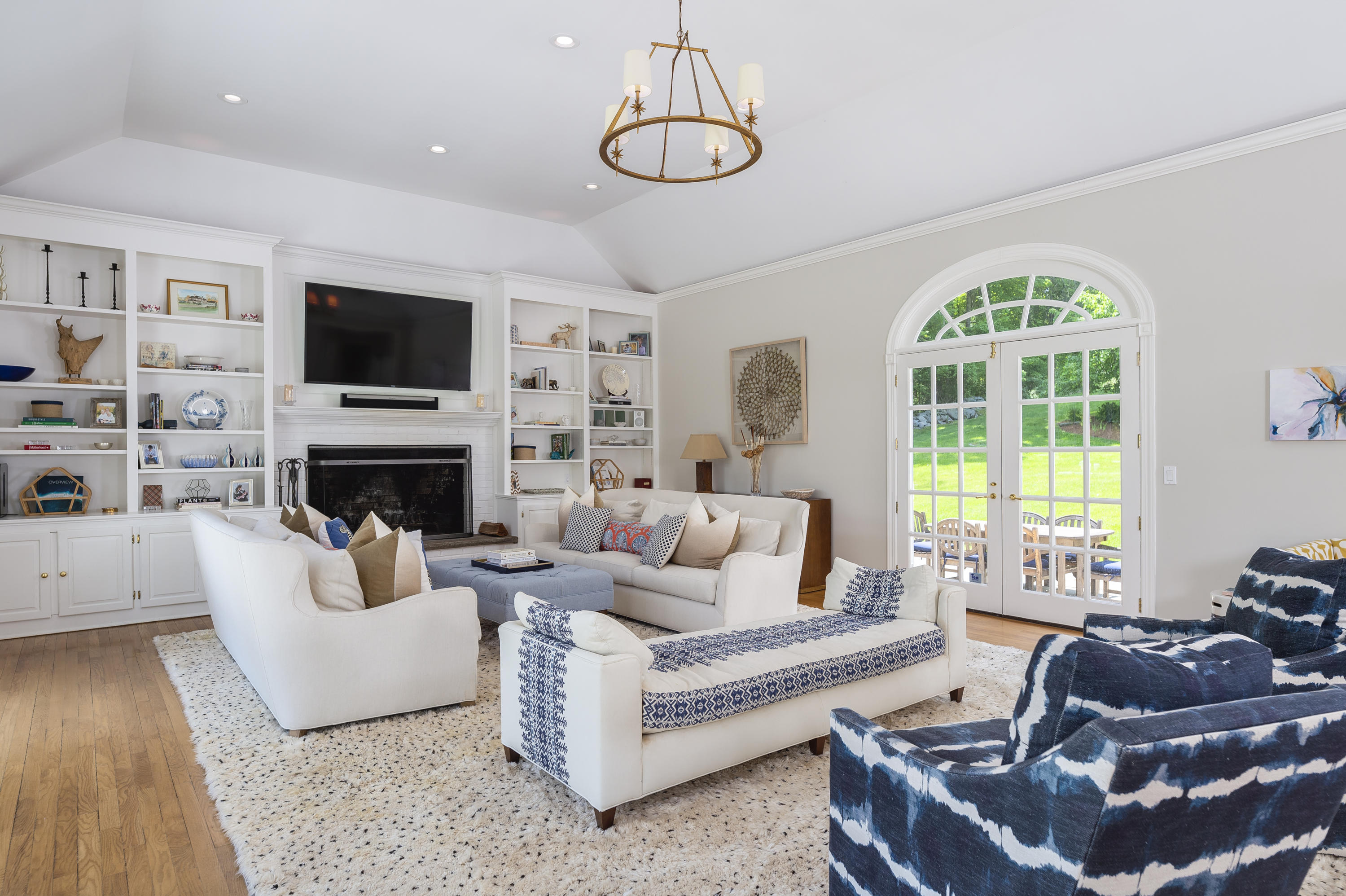 465 North Wilton Road New Canaan, CT 06840 - Photo 15 of 64 a living room with furniture a flat screen tv and a fireplace