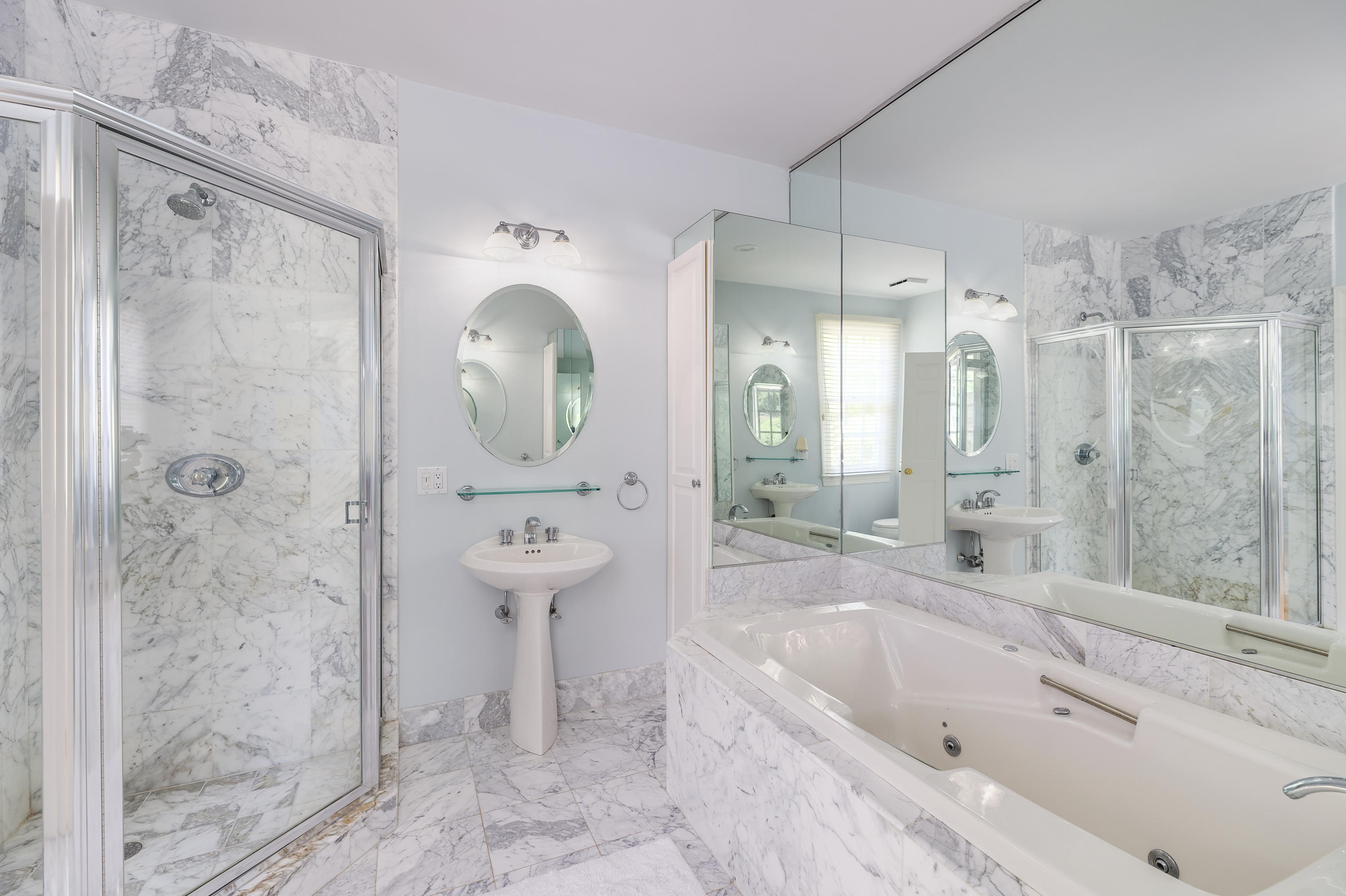 465 North Wilton Road New Canaan, CT 06840 - Photo 19 of 64 a bathroom with a bathtub shower sink and mirror