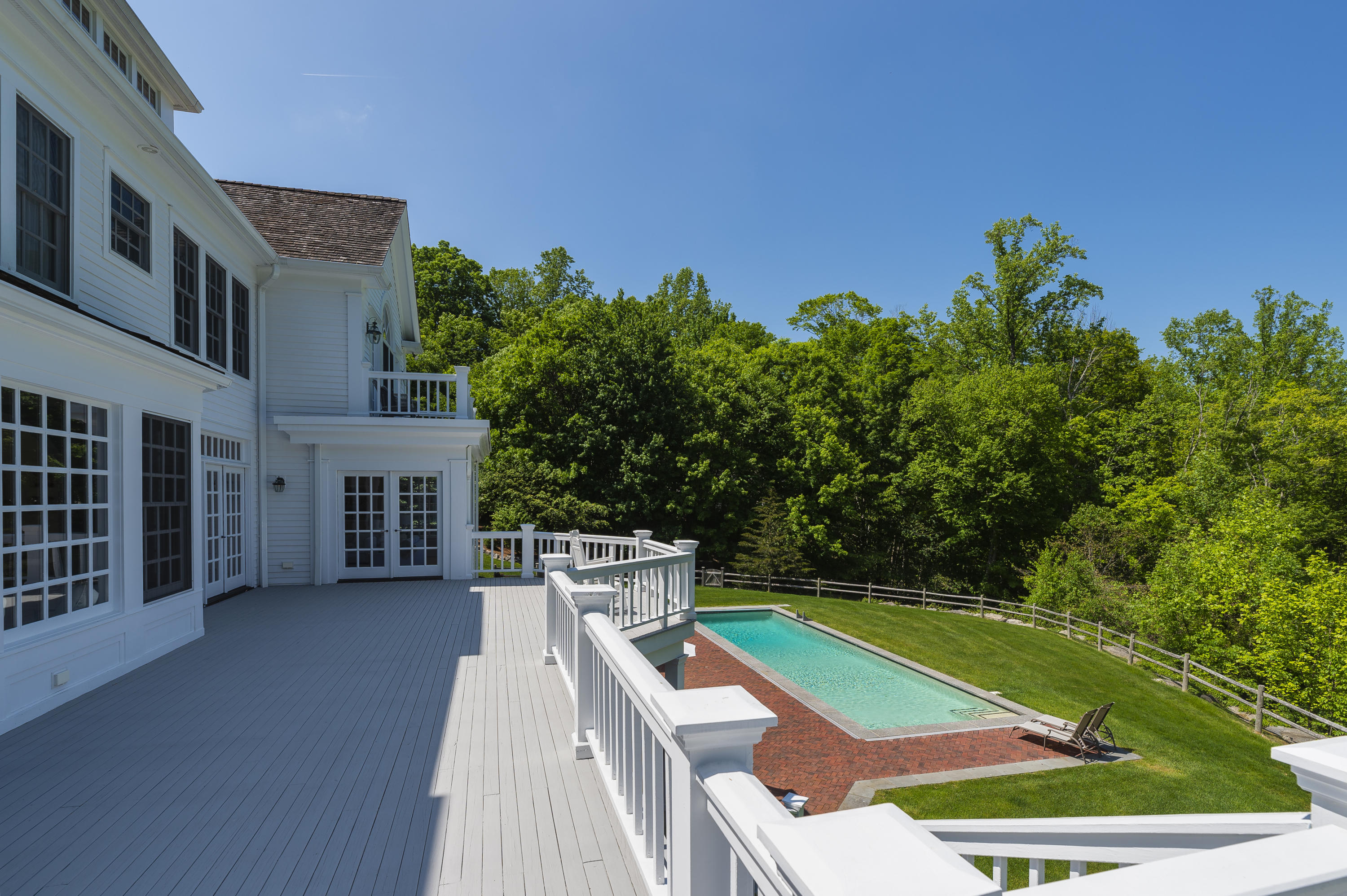 465 North Wilton Road New Canaan, CT 06840 - Photo 41 of 64 a backyard of a house with lots of green space and outdoor seating