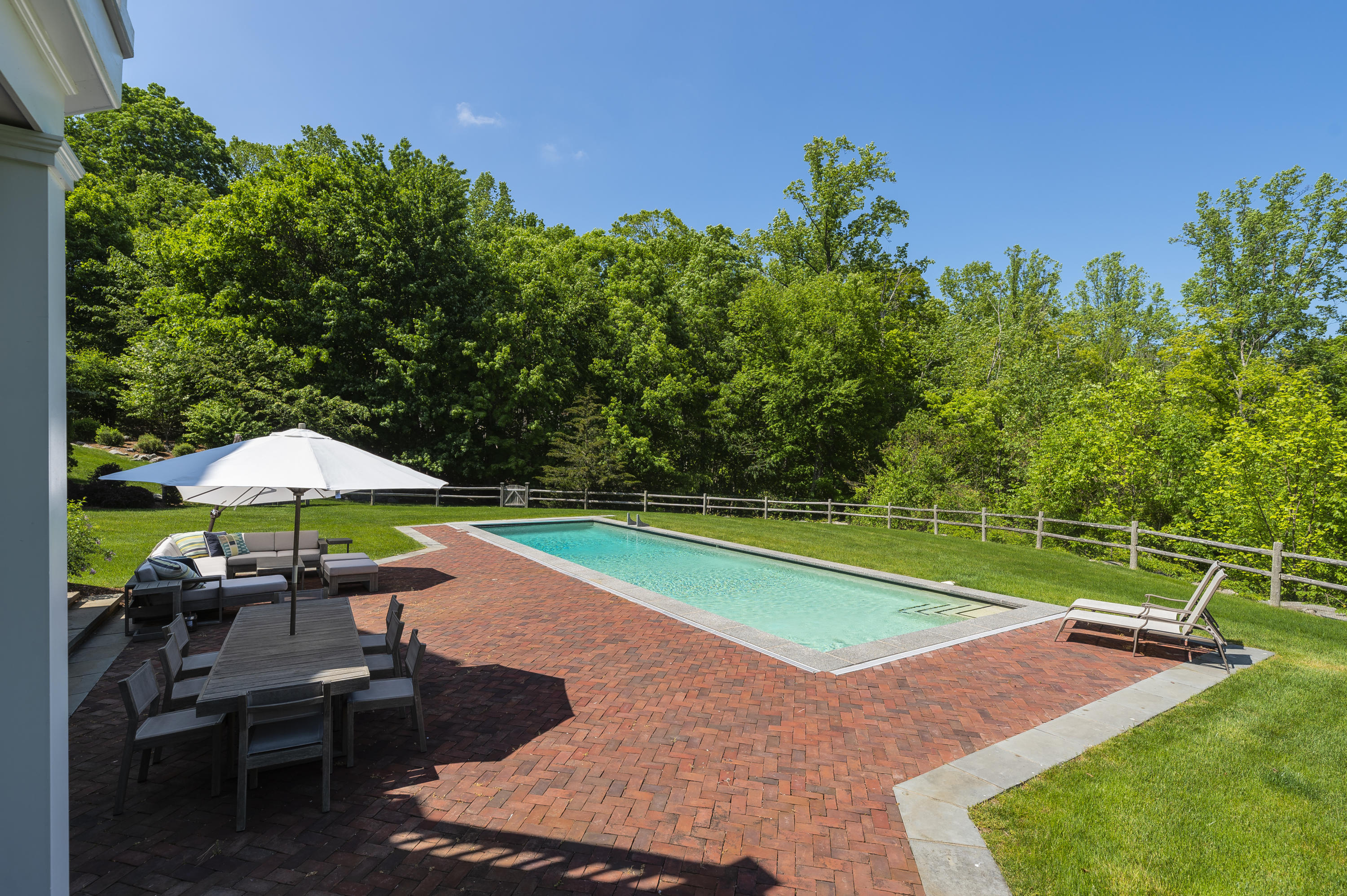 465 North Wilton Road New Canaan, CT 06840 - Photo 43 of 64 a view of a table and chairs under an umbrella