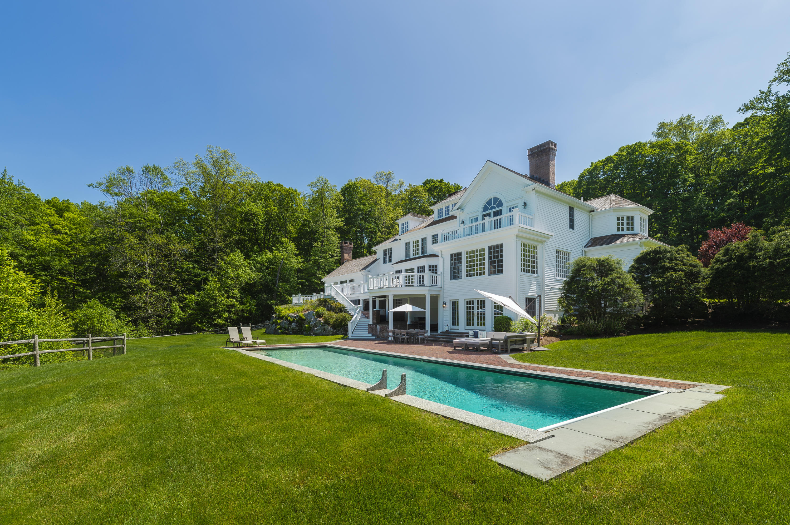465 North Wilton Road New Canaan, CT 06840 - Photo 44 of 64 a front view of house with yard and trees in the background