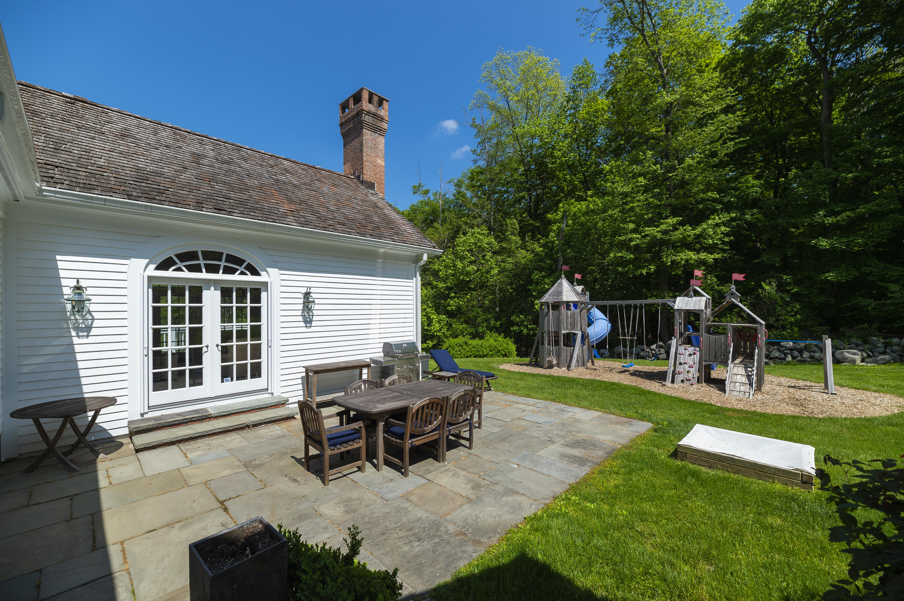 465 North Wilton Road New Canaan, CT 06840 - Photo 47 of 64 a view of a house with backyard porch and sitting area
