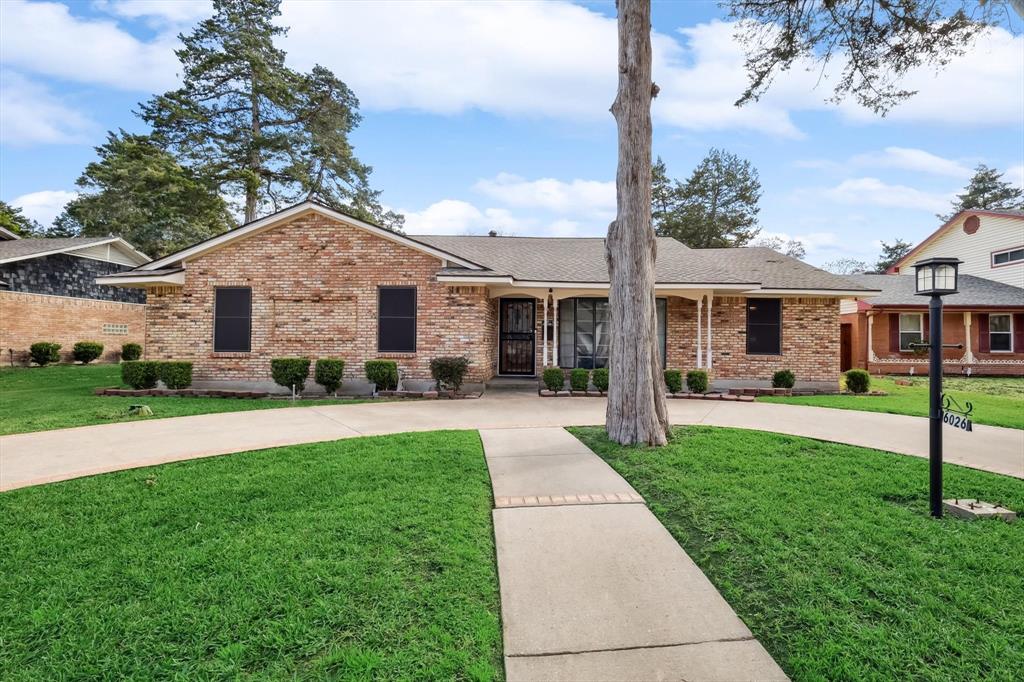 6026 Hunters View Lane Dallas, TX 75232 - Photo 1 of 1 a front view of a house with a yard