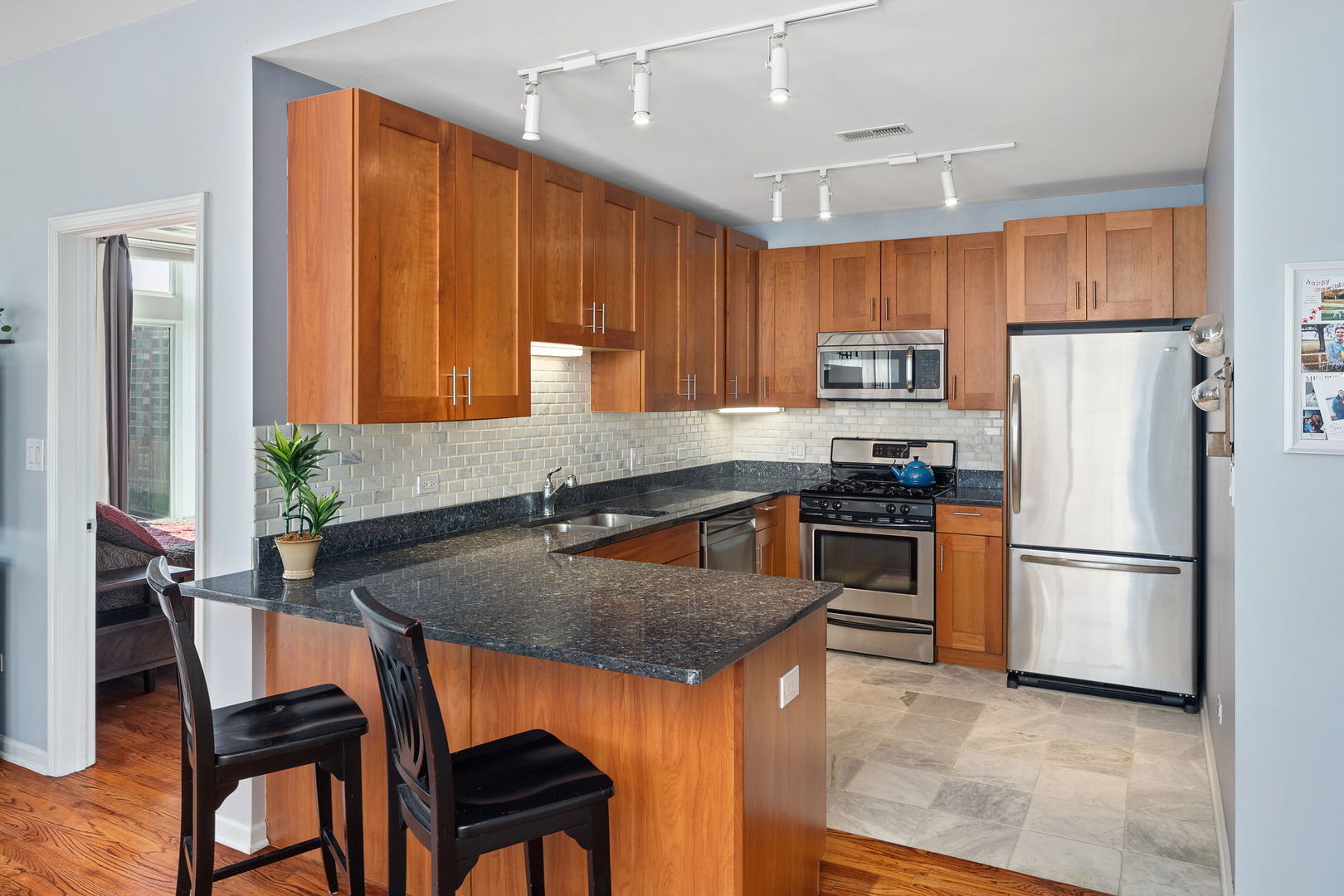 657 West Fulton Street, Unit 705 Chicago, IL 60661 - Photo 13 of 24 a kitchen with kitchen island a counter top space cabinets and stainless steel appliances