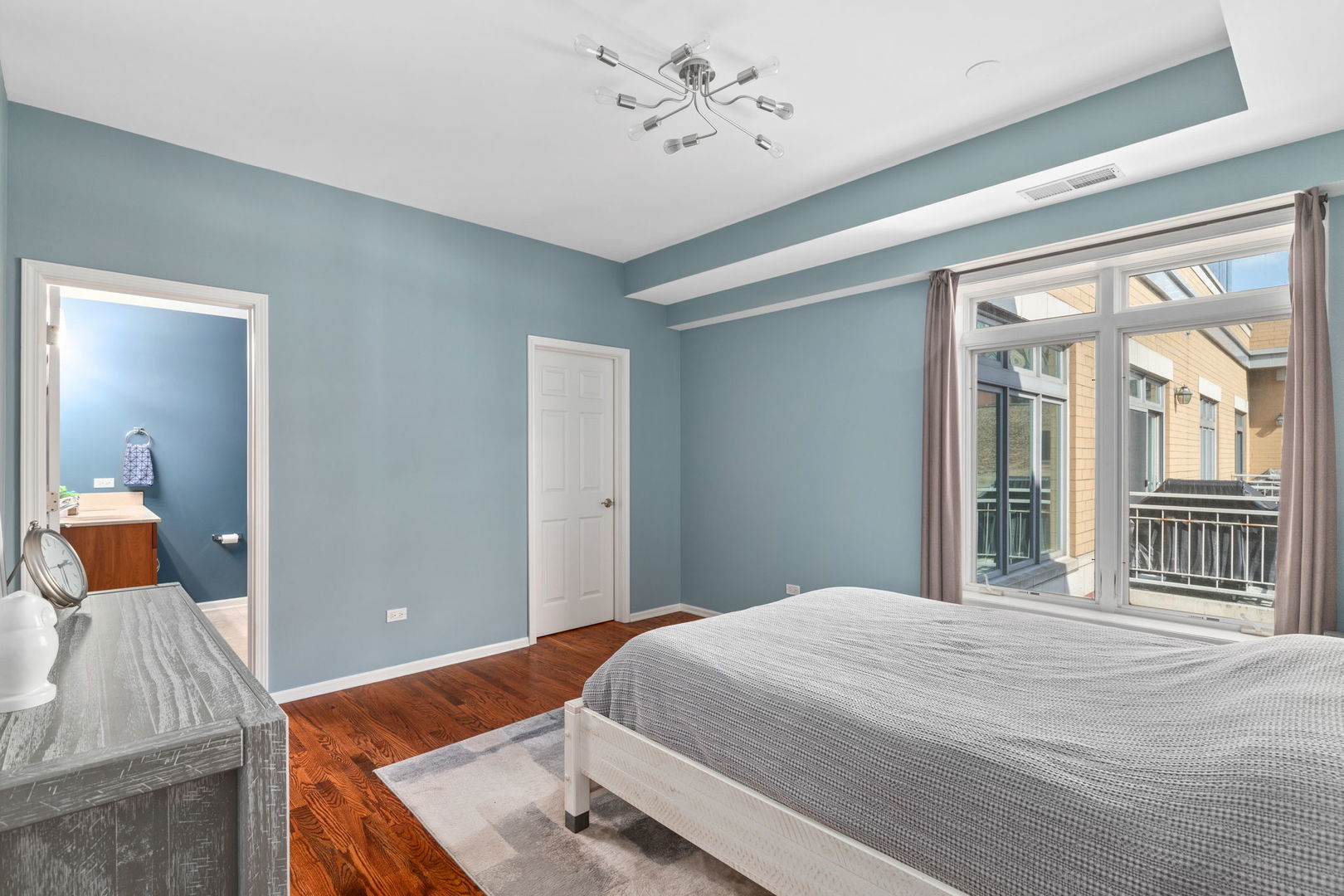 657 West Fulton Street, Unit 705 Chicago, IL 60661 - Photo 15 of 24 a bedroom with a bed and wooden floor