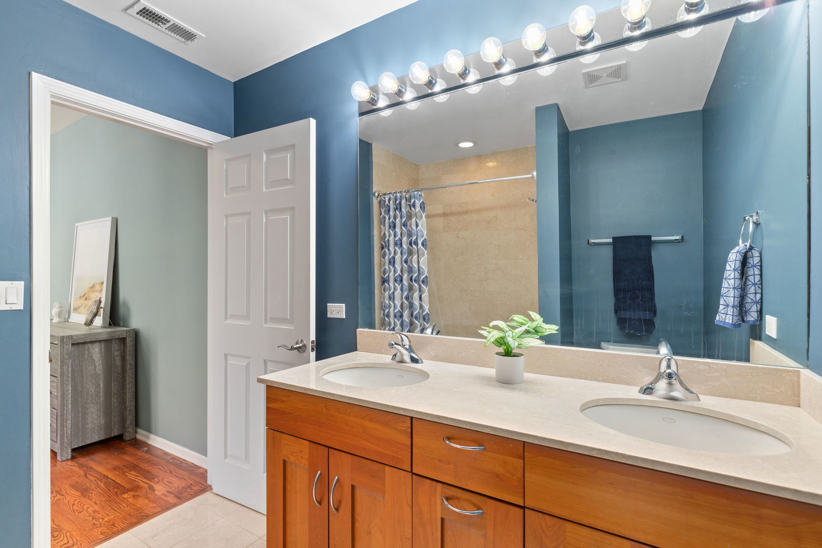 657 West Fulton Street, Unit 705 Chicago, IL 60661 - Photo 17 of 24 a bathroom with double vanity sinks a vanity and a mirror