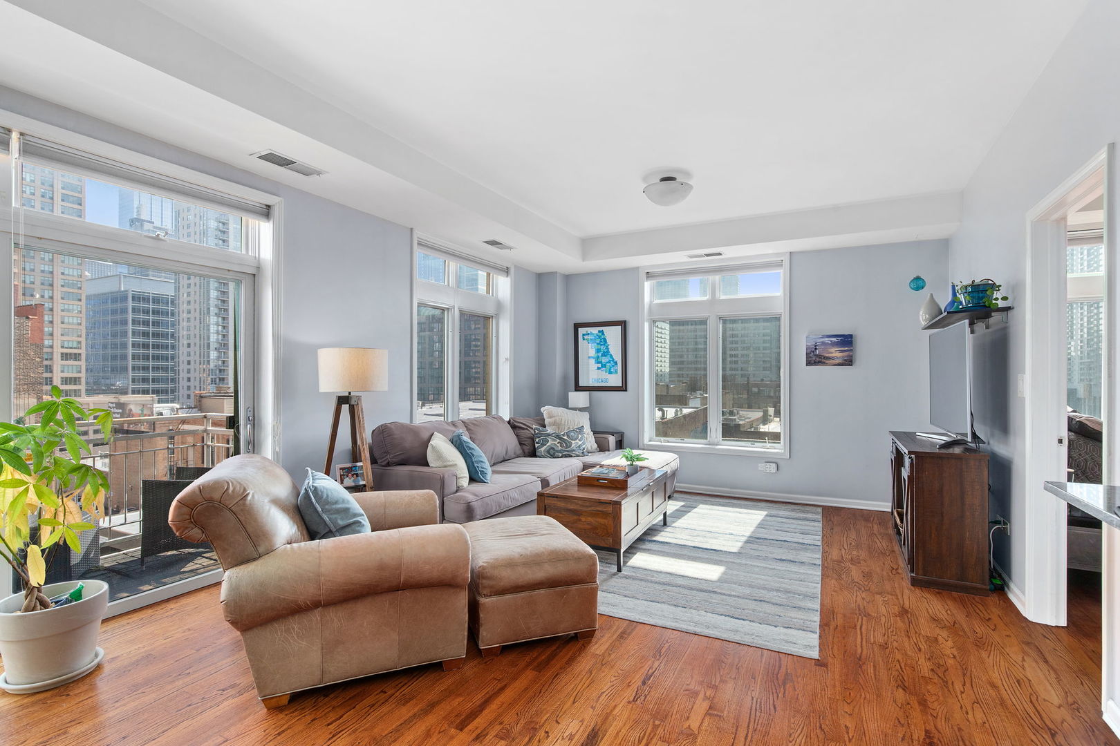 657 West Fulton Street, Unit 705 Chicago, IL 60661 - Photo 3 of 24 a living room with furniture and wooden floor