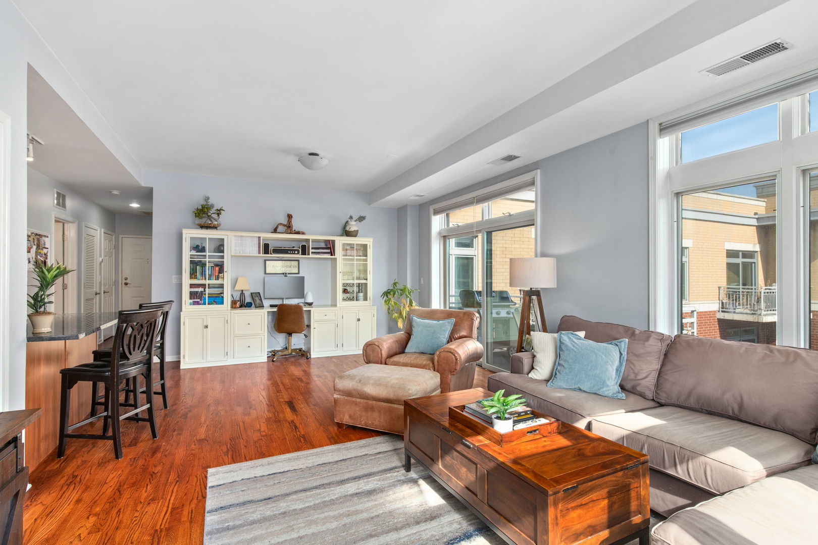 657 West Fulton Street, Unit 705 Chicago, IL 60661 - Photo 6 of 24 a living room with furniture wooden floor and a large window