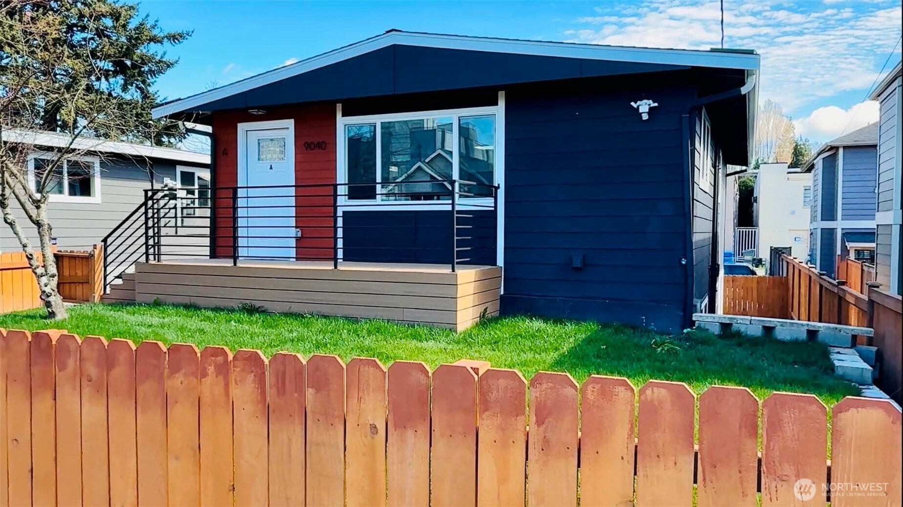 a view of a house with wooden fence