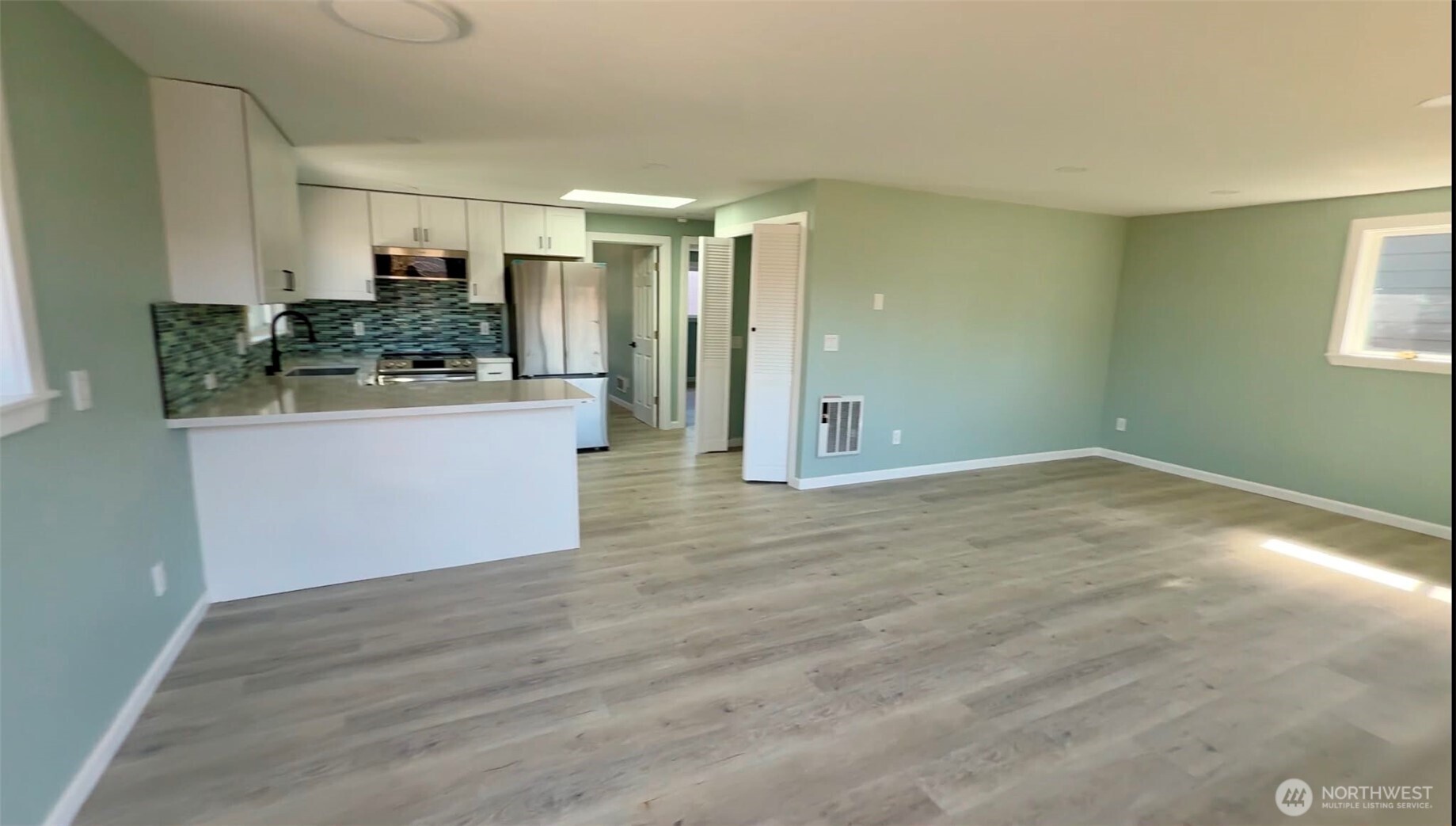 9040 17th Avenue Southwest Seattle, WA 98106 - Photo 14 of 34 a view of a kitchen cabinets and wooden floor