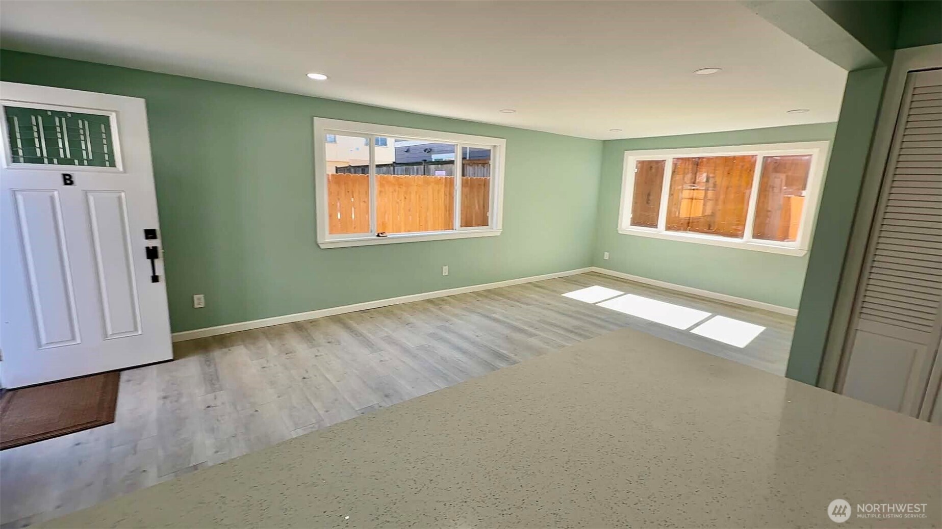 9040 17th Avenue Southwest Seattle, WA 98106 - Photo 21 of 34 a view of an empty room with window and wooden floor