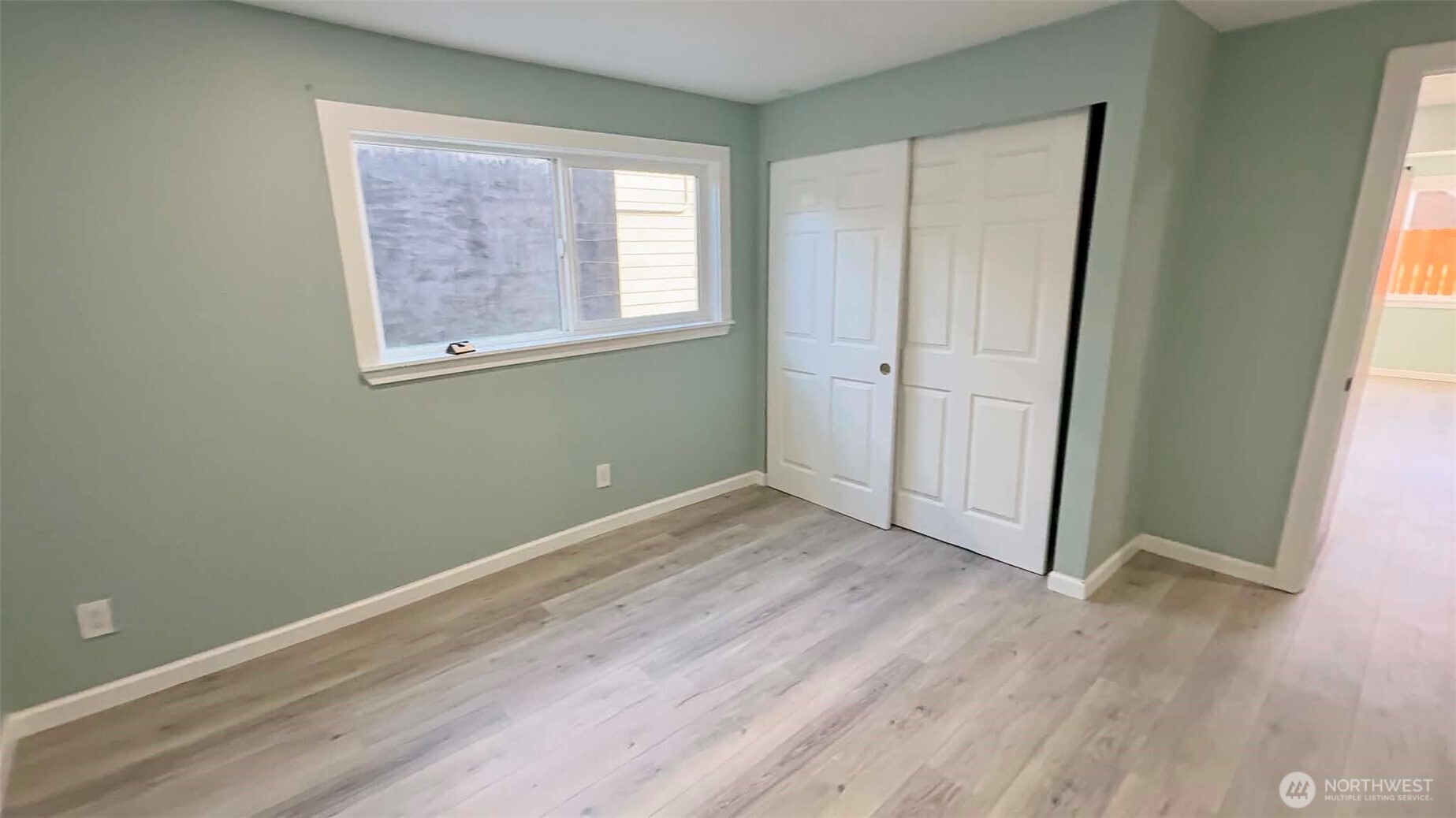 9040 17th Avenue Southwest Seattle, WA 98106 - Photo 26 of 34 an empty room with wooden floor and windows