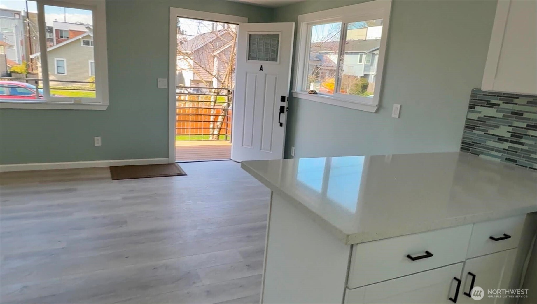 9040 17th Avenue Southwest Seattle, WA 98106 - Photo 33 of 34 a view of an empty room with window and wooden floor