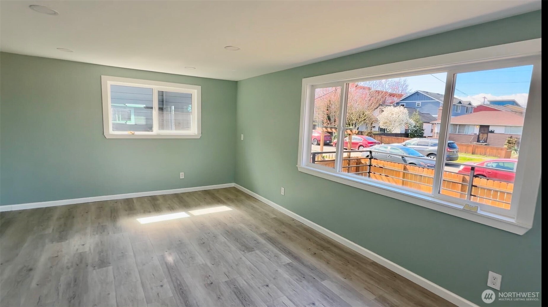 9040 17th Avenue Southwest Seattle, WA 98106 - Photo 4 of 34 a view of an empty room with wooden floor and a window