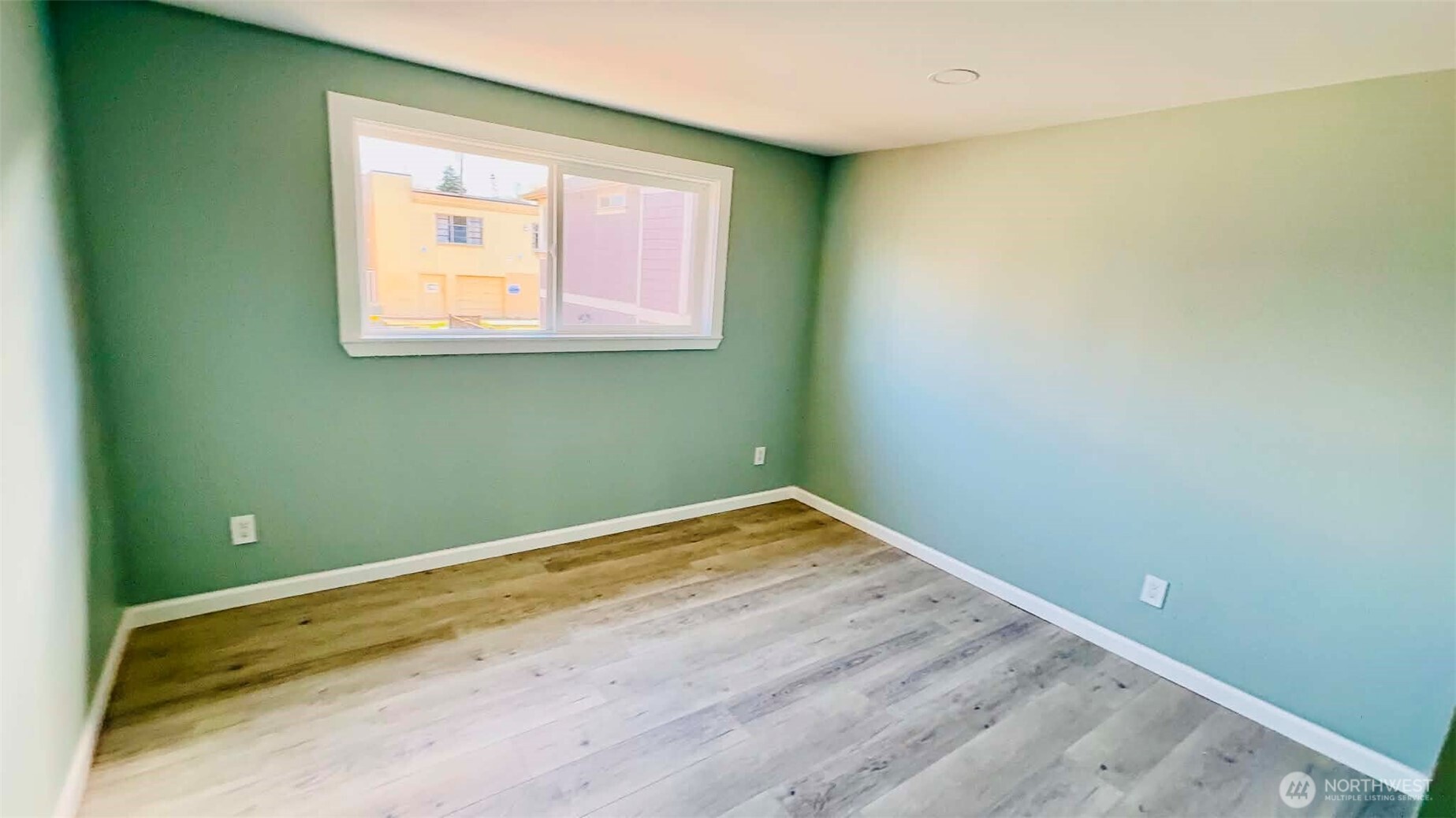 9040 17th Avenue Southwest Seattle, WA 98106 - Photo 9 of 34 a view of a room with wooden floor and a window