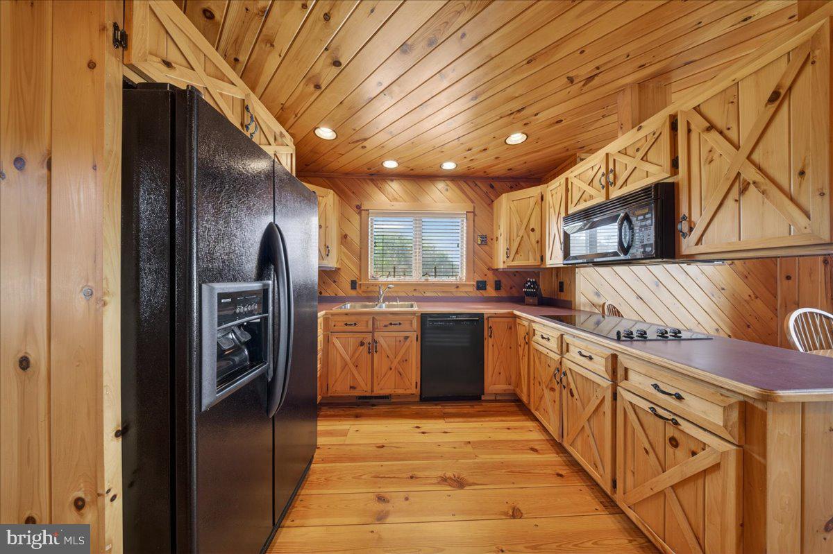10036 Redden Road Bridgeville, DE 19933 - Photo 21 of 53 a kitchen with stainless steel appliances granite countertop a refrigerator a sink and wooden cabinets