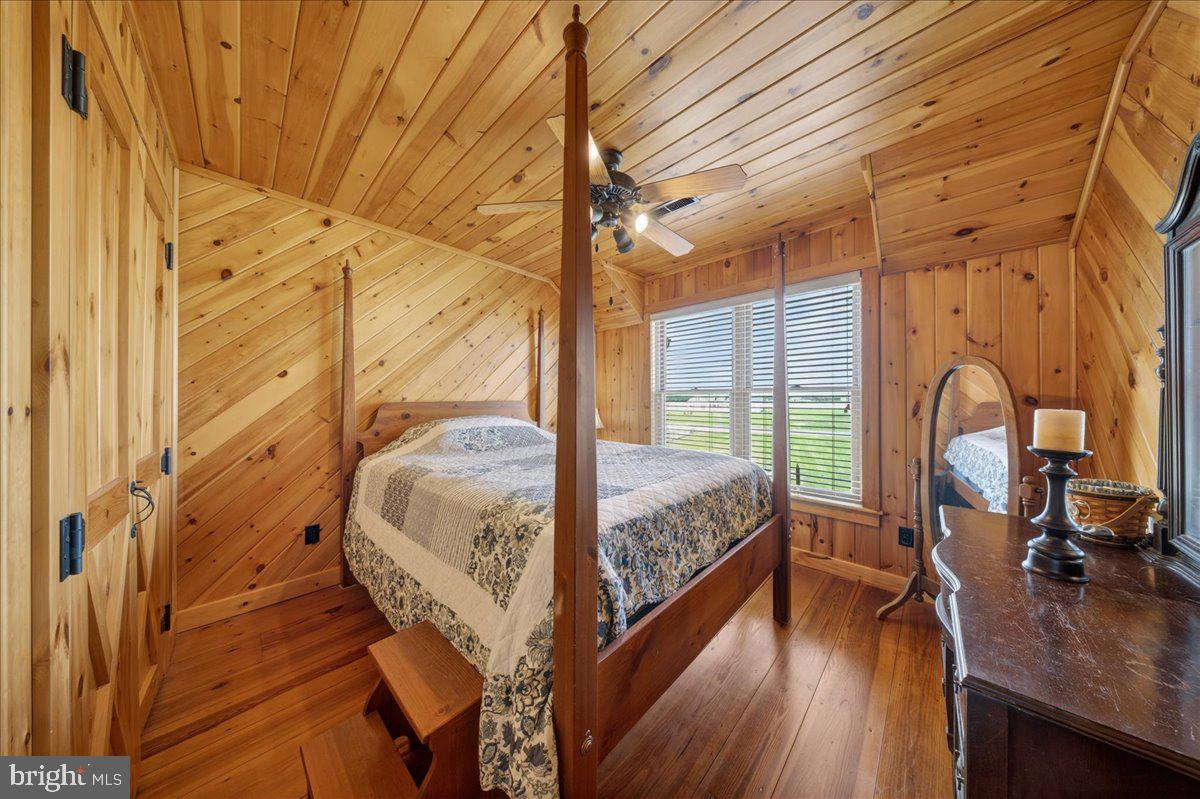10036 Redden Road Bridgeville, DE 19933 - Photo 25 of 53 a bedroom with a bed wooden floor and a large window