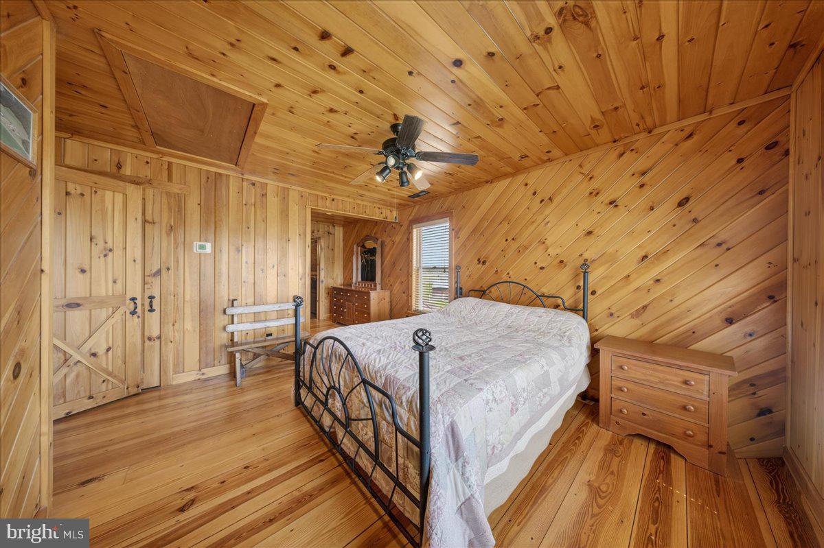 10036 Redden Road Bridgeville, DE 19933 - Photo 27 of 53 a bed room with a bed and a chandelier