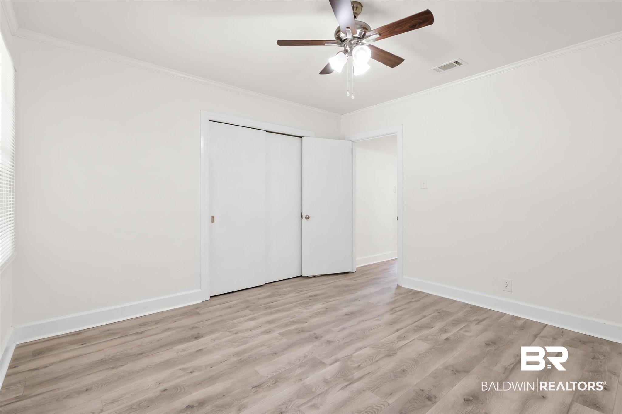 1306 Azalea Street Mobile, AL 36604 - Photo 13 of 20 Unfurnished bedroom featuring ceiling fan, ornamental molding, a closet, and light hardwood / wood-style floors
