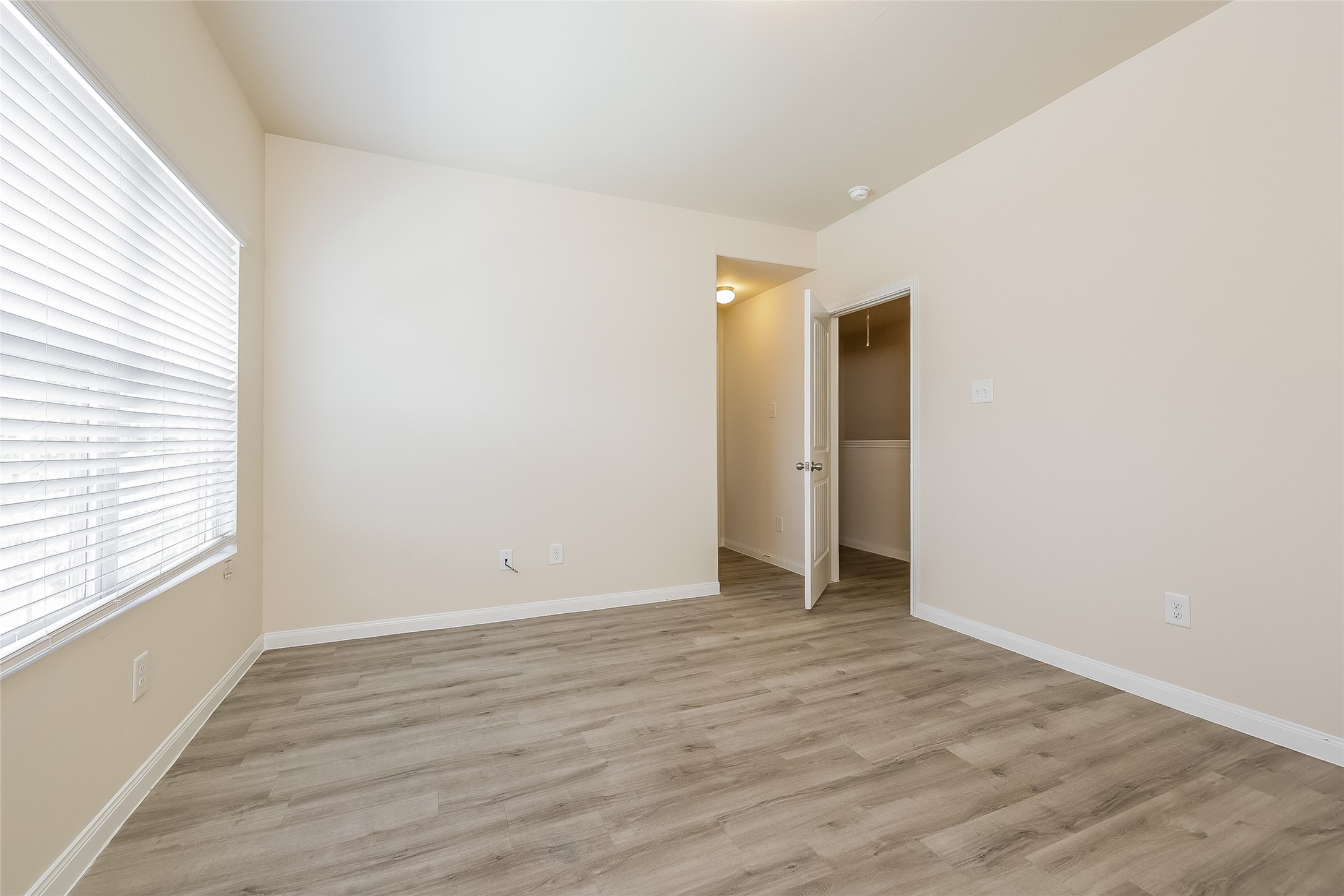 4114 Farmers Pass Road Houston, TX 77014 - Photo 14 of 15 an empty room with wooden floor and windows